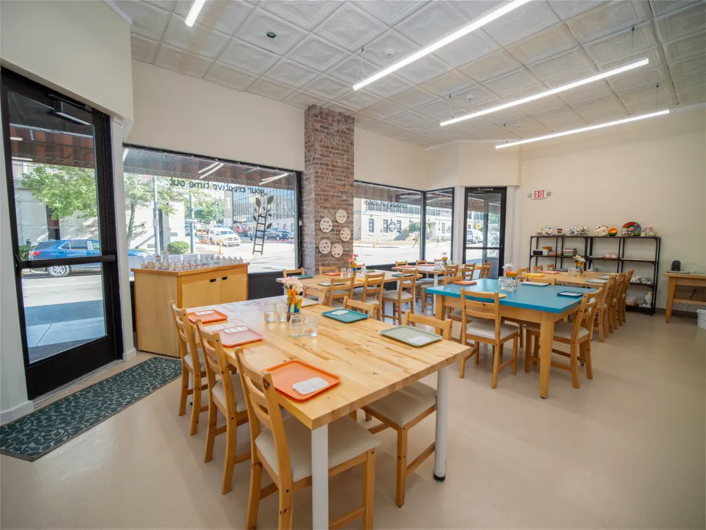 Bright studio with large tables and natural light at Pearl City Clay House in downtown Jamestown