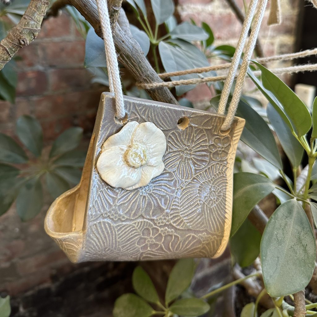 Hand-built bird house created by a student at Pearl City Clay House