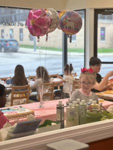 Children celebrating a birthday party while painting pottery at Pearl City Clay House in Jamestown, NY.