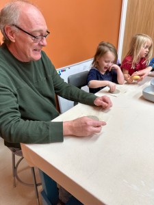Adult and children working with clay during a family hand-building session at Pearl City Clay House in Jamestown, NY.