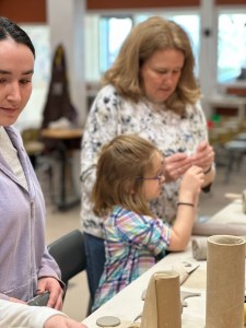 Family creating clay art together during a hand-building class at Pearl City Clay House in Jamestown, NY