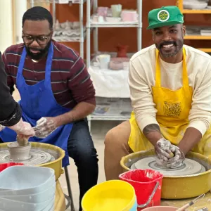 Two students learning pottery wheel techniques at Pearl City Clay House, Jamestown, NY