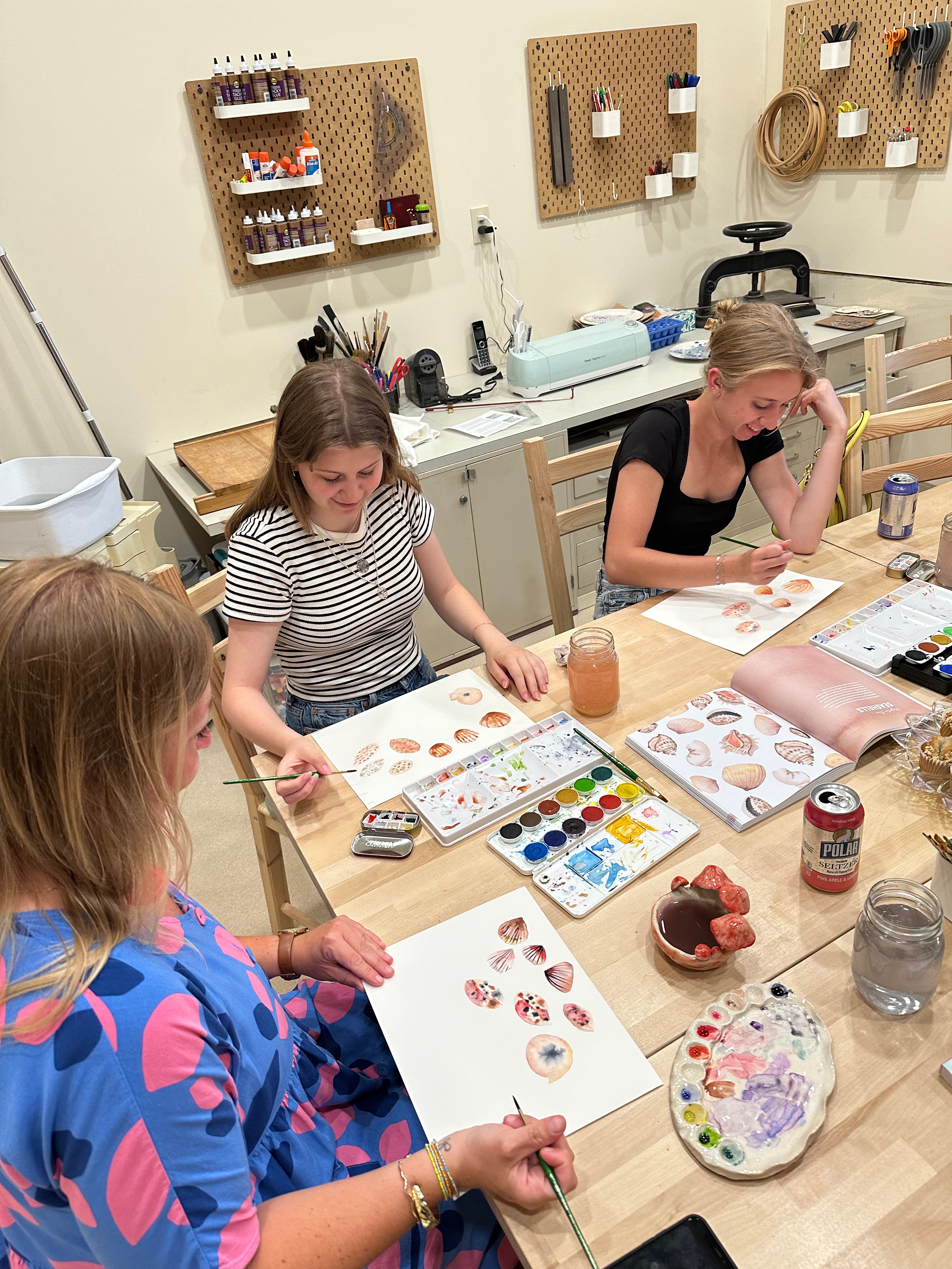 “Students painting ceramics during a watercolor pottery workshop at Pearl City Clay House in Jamestown, NY.”